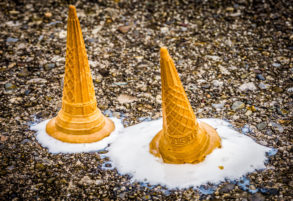melted ice cream in a cone that has been dropped on the floor