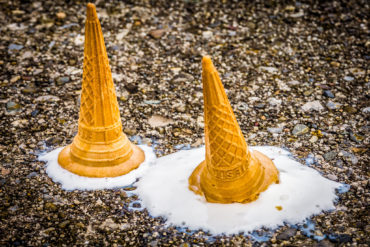 melted ice cream in a cone that has been dropped on the floor