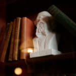 sculpture of charles dickens acting as a book end