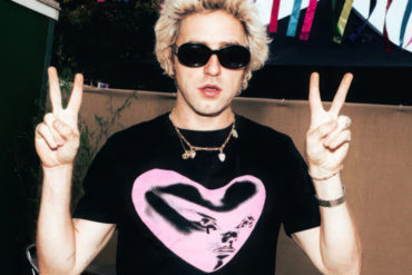Punk wearing one of the new T-shirts showing a neon pink love heart on the front