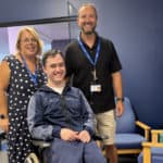 Christian Rogers with staff from the college