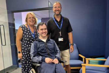 Christian Rogers with staff from the college