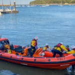 Cowes RNLI crew and paramedics transfer the casualty to the lifeboat