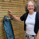 Frances standing alongside a skateboard