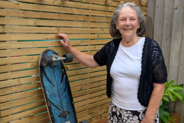 Frances standing alongside a skateboard