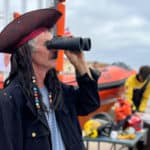 Man dressed as a Pirate looking out to sea