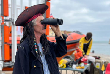 Man dressed as a Pirate looking out to sea