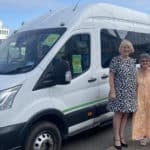 Sally and Michelle Newton standing by the new Daisy Bus minibus service with Red Funnel ferry in the background
