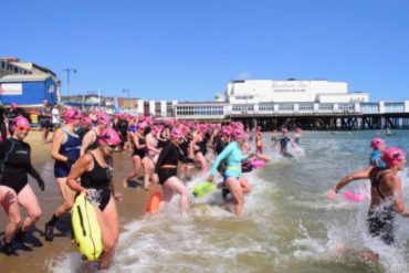 Photo of swimmers entering the water by Sandown Pier