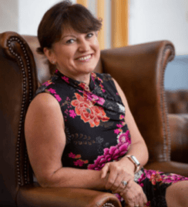 Ros Parker sat on a chair