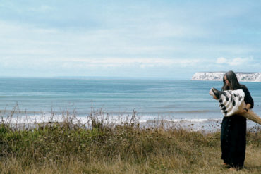 Richelle Rich standing on edge of clifftop with giant ice cream