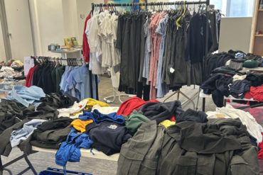 School uniform swap shop showing clothes rails and tables with school uniform