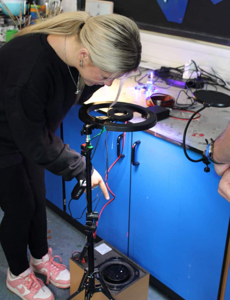 Student experimenting with cymatics