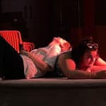 Two stroke rehearsals with two actors on stage with red lighting