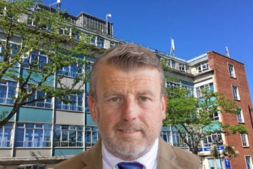 Mugshot of David Maclean overlaid on photo of county hall