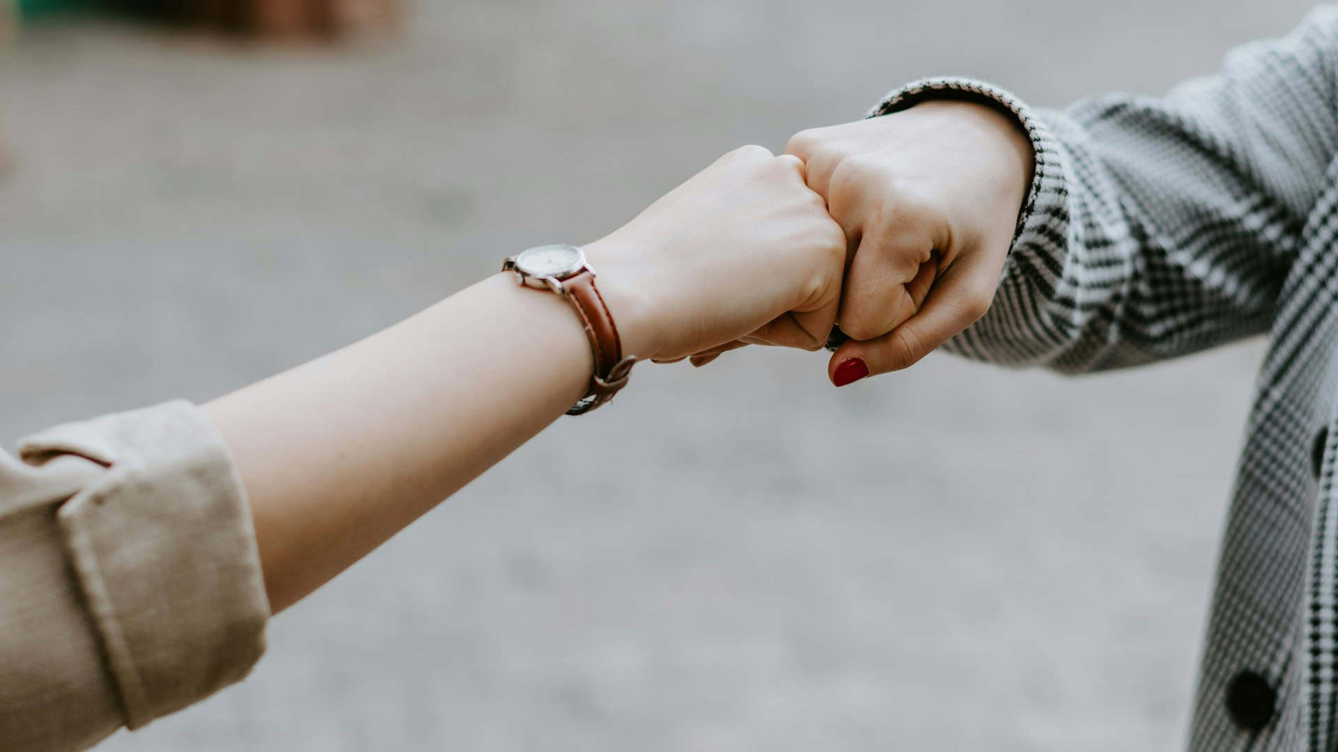 two young people bumping fists together
