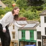 woman looking at solar panels on model village