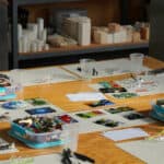 Art supplies laid out on a classroom table