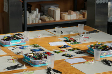 Art supplies laid out on a classroom table