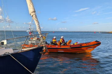 Cowes RNLI head back to the station after making the sailing boat secure