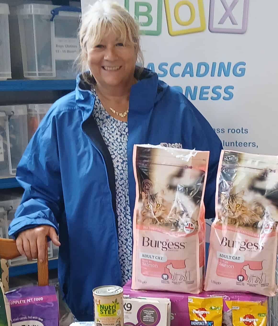 Woman at Baby Box with pet food donations