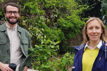 Joe Lever and Claire Critchison standing in a green garden