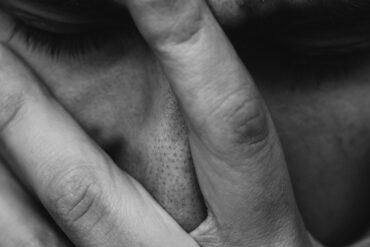 Man holding his head in his hands