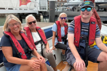 People on a boat with Cowes Sailability