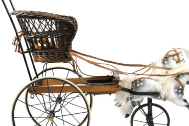 Queen Victoria's pushchair - a wicker seat for the child to be placed in and a pair of dappled grey horses at the front, that gallop up and down when pushed