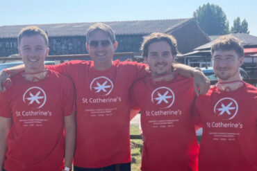 Four men dressed in St Catherine's School T-shirts getting read to take part in the sky dive