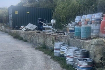 area where beach huts will go - currently storing large metal cannisters