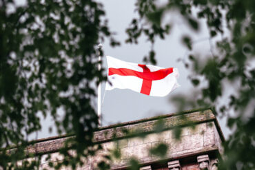 england st george's cross flag flying from flagpole