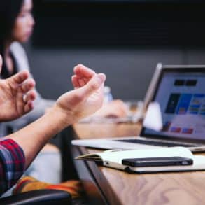 people sat around a table in a meeting by headway