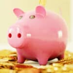 piggy bank with gold coins around it