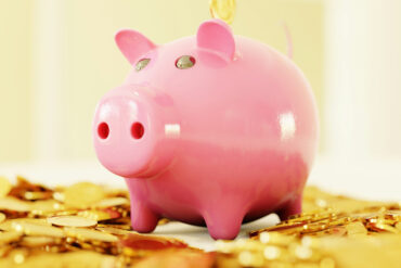 piggy bank with gold coins around it
