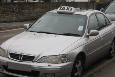 silver taxi waiting on the road