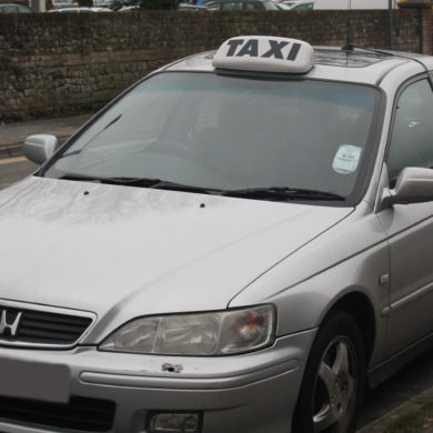 silver taxi waiting on the road
