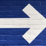 white arrow on blue painted wall