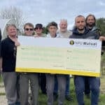 John Heather Senior Agent at NFU Mutual New Forest, Isle of Wight and Bournemouth (far left), with Nichola Cook, Manager at Haylands Farm (second from left) and volunteers at the Farm