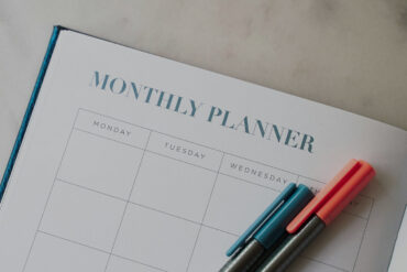 Monthly planner notebook and pens