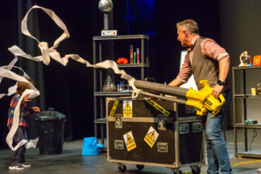 Mark Thompson on stage with all his scientific equipment