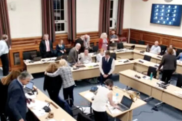 Screen grab of councillor gladwin being comforted out of the chamber