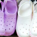 children's croc shoes hanging on rack