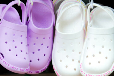 children's croc shoes hanging on rack