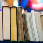 line of books with blurry background