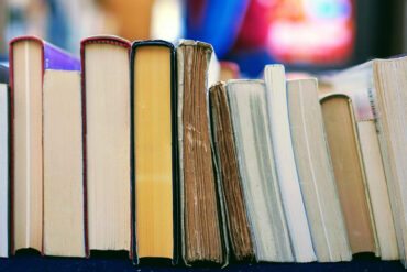 line of books with blurry background