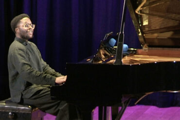 Amiri Harewood at the gran piano