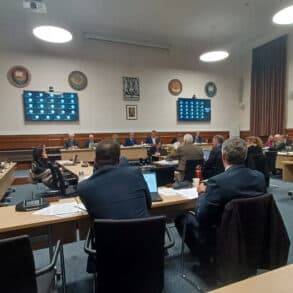 Full Council meeting - councillors sat at tables in the room