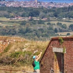 Person photographing part of Bembridge Fort, with the Solent and Mainland in the distance
