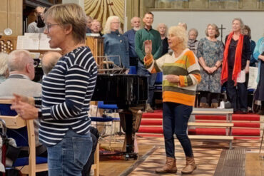 Pam Wedgwood, centre, and Lesley Mariner, conducting the Dementia Friendly choir and the Bay Wailers